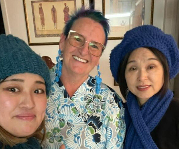 Kim with students wearing the toques she had made them.