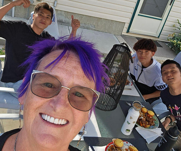 Kim sharing a meal with students in her backyard.