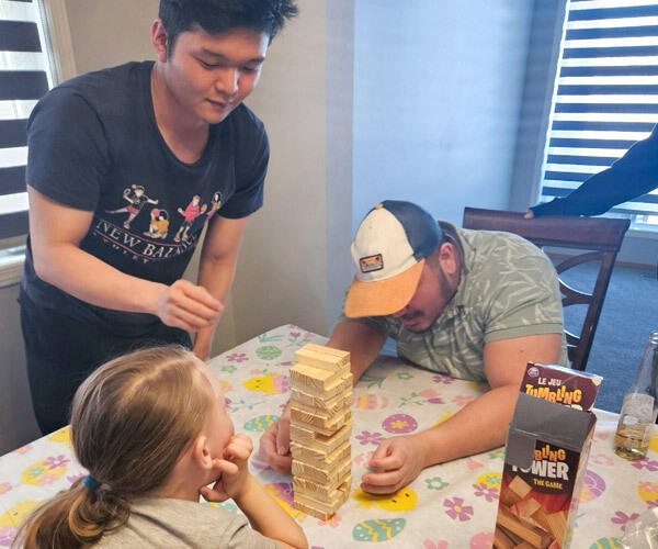 Students playing games with family.