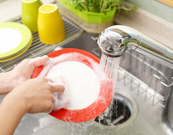 Student washing dishes.