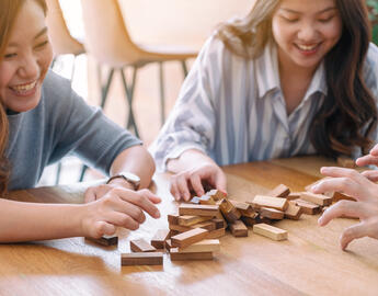 Family and student playing a game.