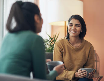 Homestay host and student talking over coffee.